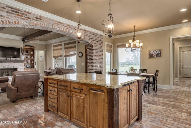 kitchen featuring brick floor, a fireplace, baseboards, and crown molding