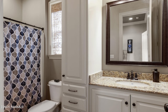 bathroom with toilet, a shower with shower curtain, and vanity