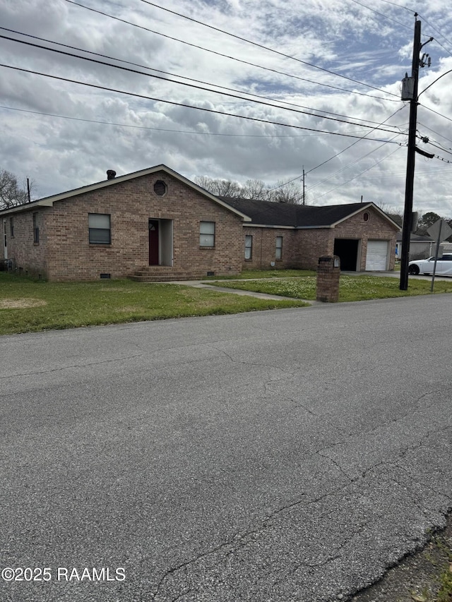 view of front of home with crawl space, an outbuilding, a front lawn, and brick siding