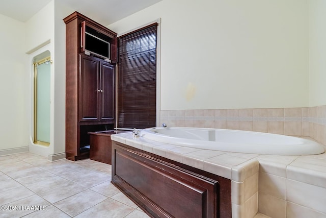 full bathroom with tile patterned flooring and a bath