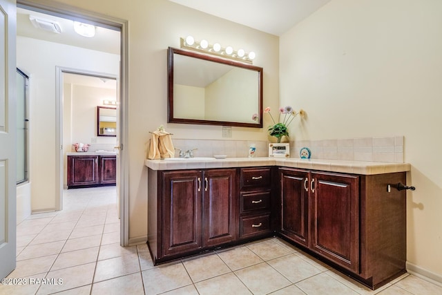 full bathroom with tile patterned flooring, vanity, and baseboards