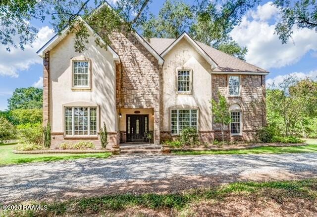 view of front facade featuring french doors and brick siding