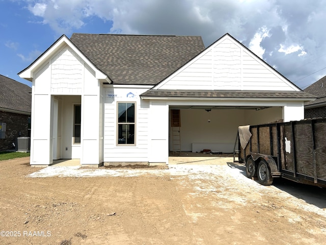 211 Bennington Ln, Youngsville, LA 70592 - view of front of property with a shingled roof, asphalt driveway, central AC unit, and a garage