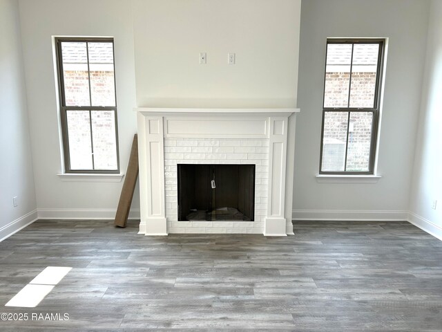 211 Bennington Ln, Youngsville, LA 70592 - detailed view of wood finished floors, baseboards, and a brick fireplace