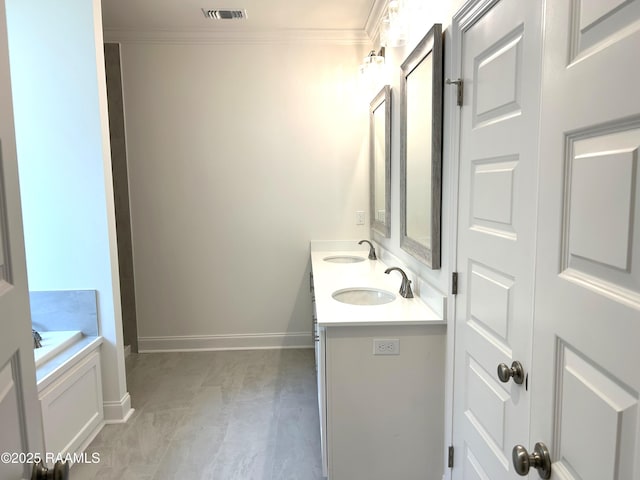 211 Bennington Ln, Youngsville, LA 70592 - bathroom with double vanity, baseboards, and a bathtub