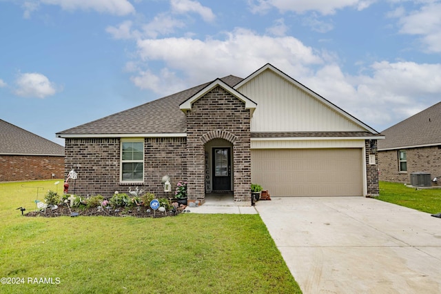 view of front facade with brick siding, an attached garage, a front lawn, roof with shingles, and driveway