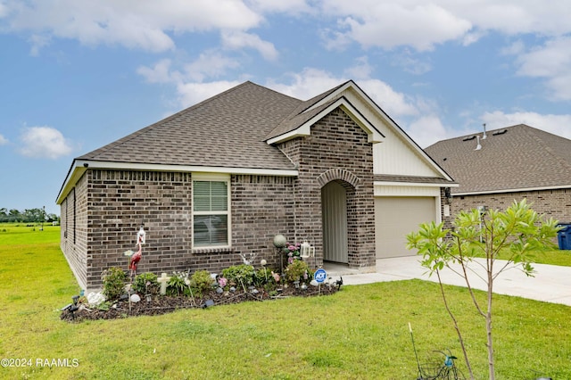 view of front of house with an attached garage, a shingled roof, concrete driveway, a front lawn, and brick siding