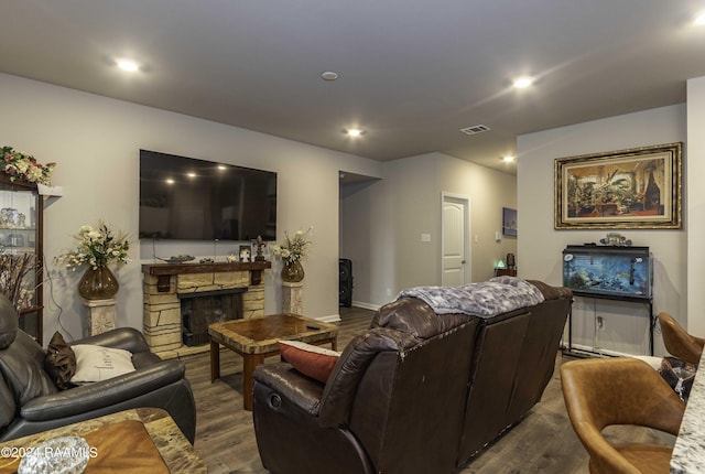 living room with recessed lighting, visible vents, dark wood finished floors, and a fireplace