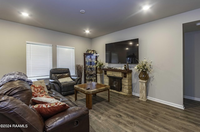 living area with recessed lighting, a fireplace, baseboards, and wood finished floors