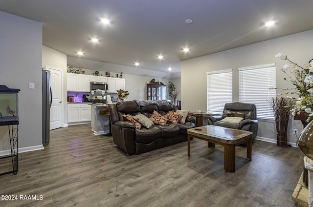 living area with recessed lighting, dark wood-style floors, and baseboards