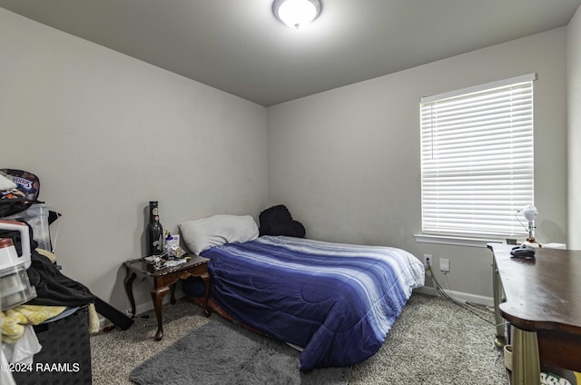 bedroom with baseboards and carpet