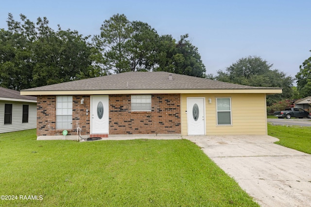 ranch-style house featuring a front lawn, brick siding, and roof with shingles