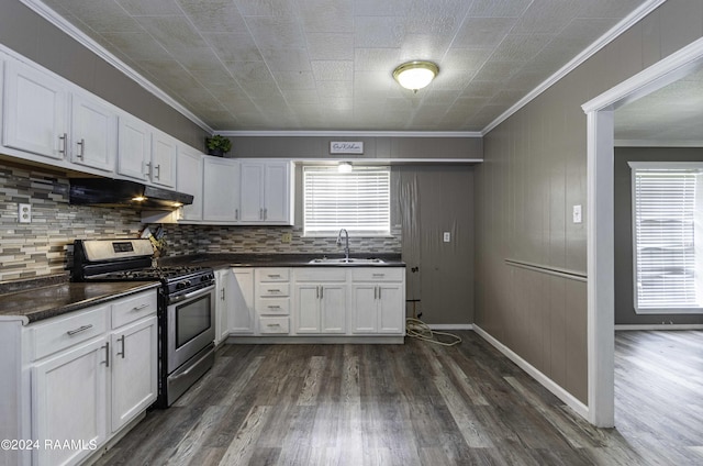 kitchen featuring a sink, white cabinets, under cabinet range hood, stainless steel gas range oven, and dark countertops