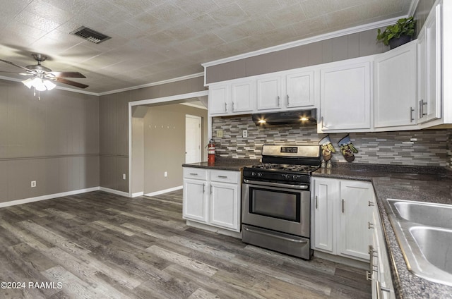 kitchen with stainless steel gas range oven, visible vents, dark wood finished floors, under cabinet range hood, and white cabinets