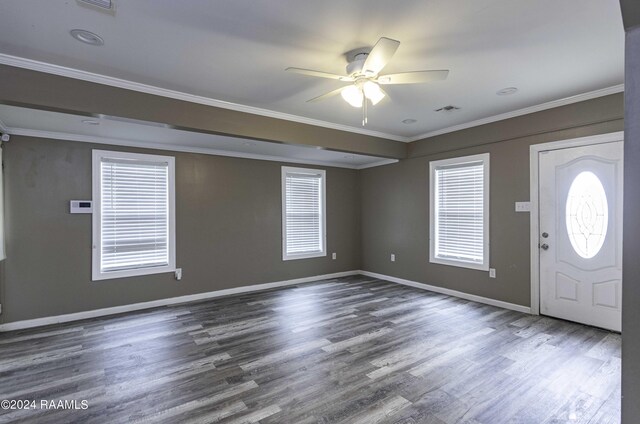 foyer entrance featuring visible vents, wood finished floors, baseboards, and ornamental molding