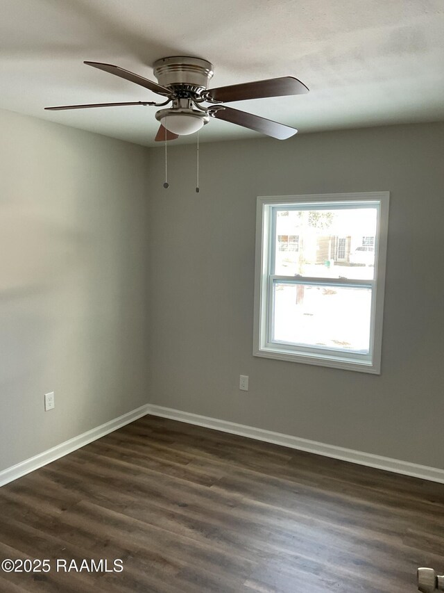 unfurnished room with ceiling fan, baseboards, and dark wood finished floors