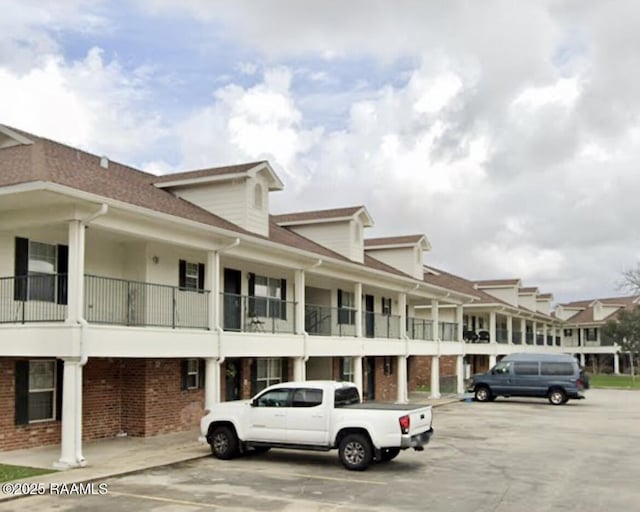 view of property featuring uncovered parking