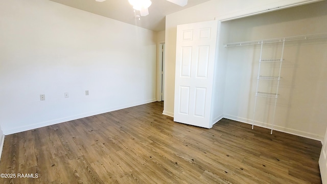 unfurnished bedroom featuring a closet, baseboards, and wood finished floors