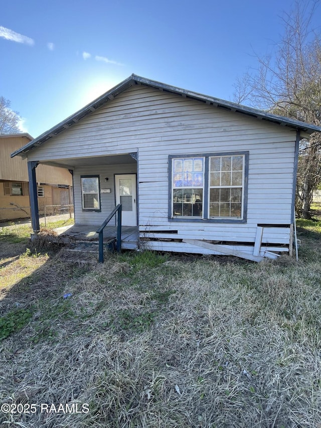 rear view of property with covered porch