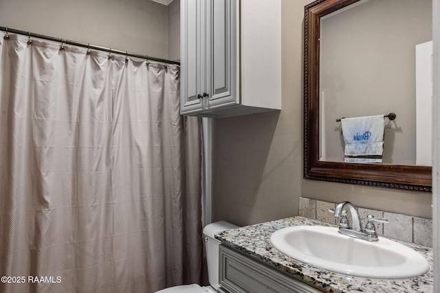 bathroom featuring toilet and vanity