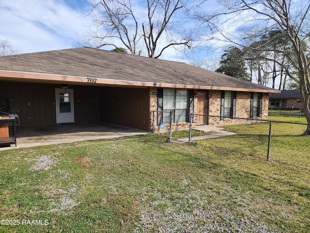 view of front facade featuring brick siding, board and batten siding, fence, roof with shingles, and a front yard