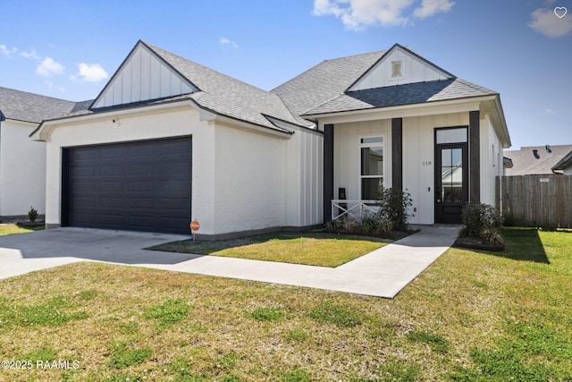 modern farmhouse style home featuring board and batten siding, a shingled roof, a front yard, a garage, and driveway