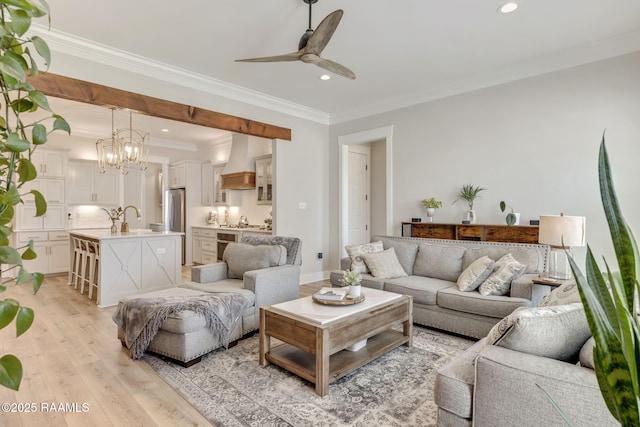 living room with a ceiling fan, recessed lighting, crown molding, light wood finished floors, and baseboards