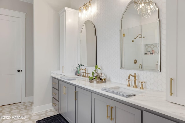 bathroom with double vanity, a stall shower, wallpapered walls, and a sink