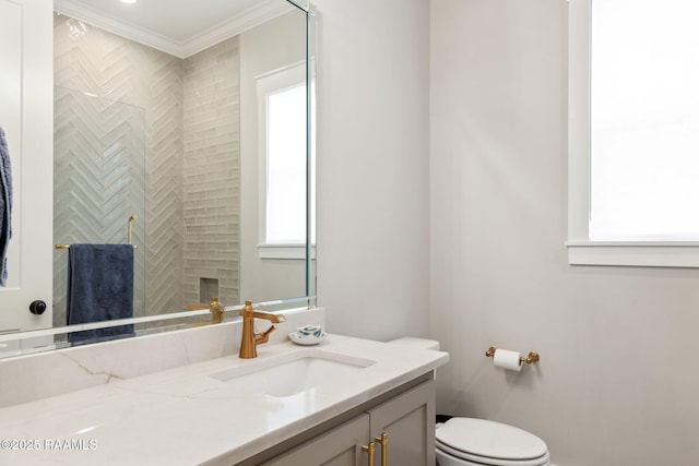 bathroom with a shower, toilet, vanity, and crown molding