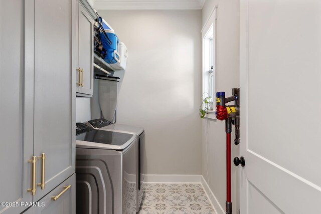 washroom featuring washer and dryer, cabinet space, baseboards, and ornamental molding