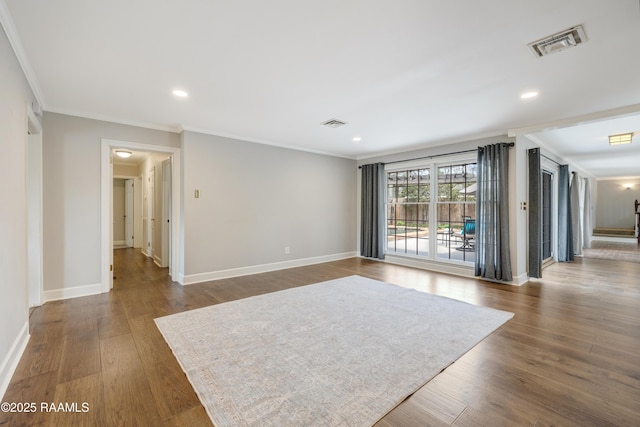 spare room with visible vents, dark wood-type flooring, and baseboards