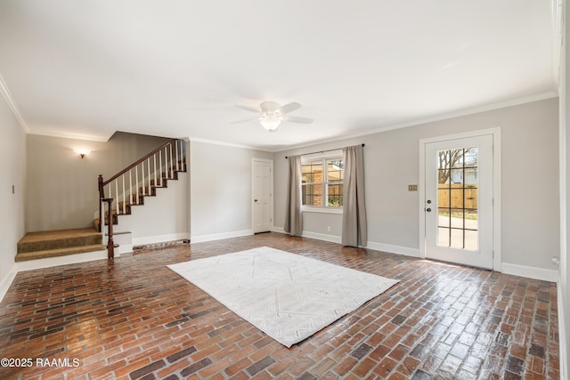 foyer entrance featuring brick floor, baseboards, and ornamental molding