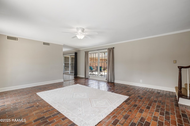 unfurnished room featuring visible vents, ceiling fan, and baseboards