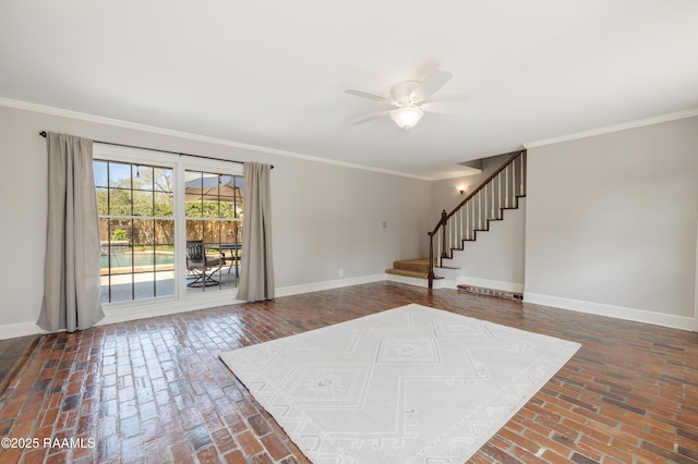 foyer featuring baseboards, stairs, ornamental molding, brick floor, and a ceiling fan