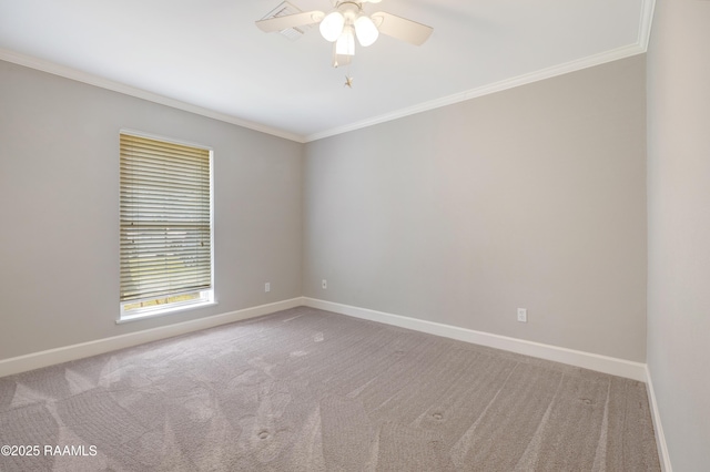 empty room with ceiling fan, carpet flooring, baseboards, and ornamental molding