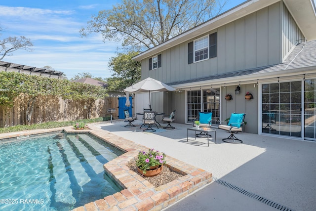 view of pool with a patio area, a fenced in pool, and fence