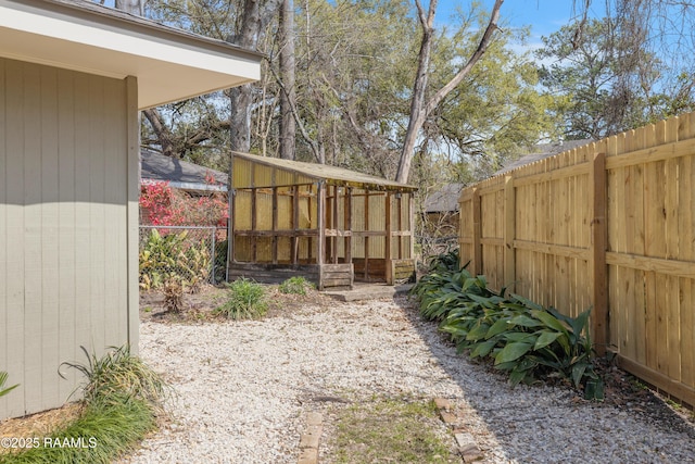 view of yard with an outbuilding and a fenced backyard