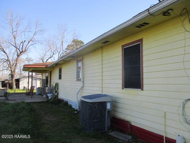 view of home's exterior featuring central air condition unit and a patio area