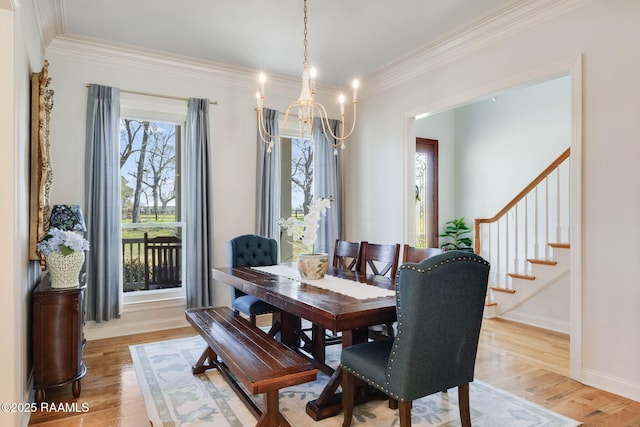 dining area featuring baseboards, light wood-style floors, ornamental molding, and stairs