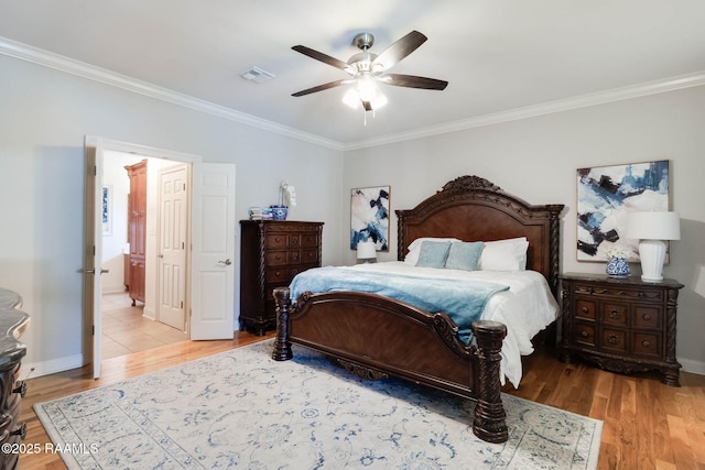 bedroom featuring visible vents, crown molding, baseboards, ceiling fan, and light wood-type flooring