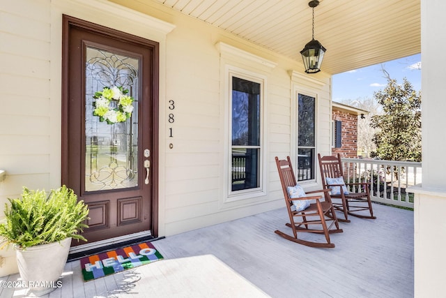 doorway to property featuring covered porch