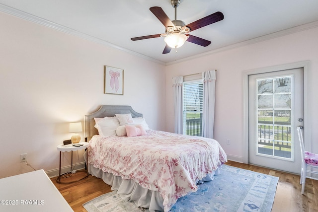 bedroom featuring access to outside, wood finished floors, baseboards, and ornamental molding