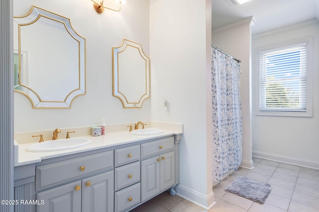 full bath featuring tile patterned floors, double vanity, baseboards, and a sink