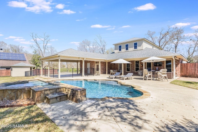 view of pool with a fenced in pool, a patio, an in ground hot tub, and fence