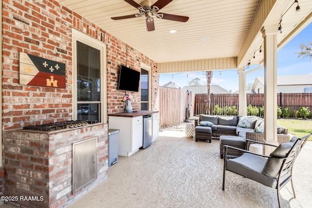 view of patio featuring an outdoor living space, ceiling fan, and fence