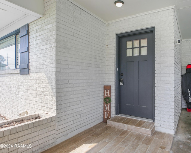 doorway to property with brick siding