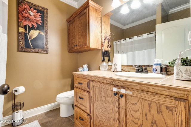 bathroom featuring tile patterned flooring, baseboards, toilet, ornamental molding, and vanity