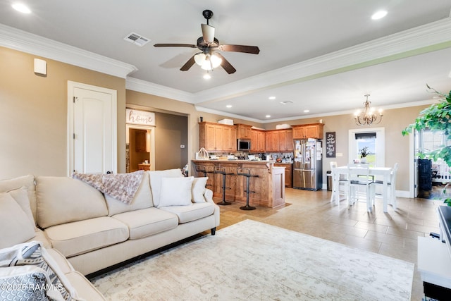 living area featuring light tile patterned floors, visible vents, recessed lighting, crown molding, and ceiling fan with notable chandelier