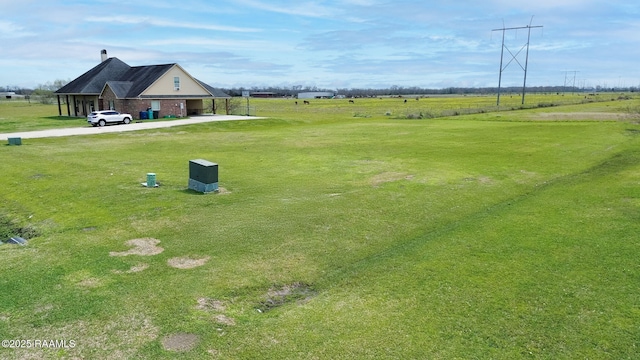 view of yard with a rural view