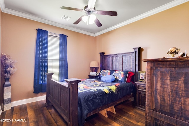 bedroom with visible vents, baseboards, wood finished floors, and crown molding